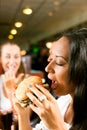 Friends eating fast food in a restaurant Royalty Free Stock Photo