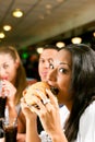 Friends eating fast food in a restaurant Royalty Free Stock Photo