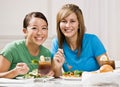 Friends eating healthy lunch and smiling Royalty Free Stock Photo