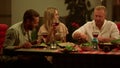 Friends eating meal during dinner. Men and woman talking at dining table Royalty Free Stock Photo