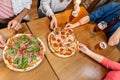 friends eating pizza with beer at restaurant Royalty Free Stock Photo