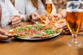 friends eating pizza with beer at restaurant Royalty Free Stock Photo