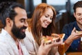 Friends eating pizza with beer at restaurant Royalty Free Stock Photo