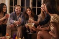 Friends Eating Snacks As They Celebrate At Party Together Royalty Free Stock Photo