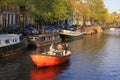 Friends enjoy a boat ride in the canals of Amsterdam