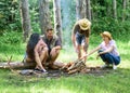Friends enjoy weekend barbecue in forest. Company friends picnic or barbecue roasting food near bonfire. Best friends Royalty Free Stock Photo