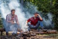 Friends enjoy weekend camp in forest. Happy young friends having picnic in the country. Friends couples enjoy vacation Royalty Free Stock Photo