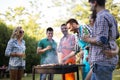 Friends enjoying bbq party and smiling in forest Royalty Free Stock Photo
