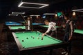 Friends enjoying billiard game at pool hall Royalty Free Stock Photo