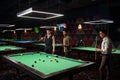 Friends enjoying billiard game at pool hall Royalty Free Stock Photo