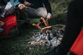 Friends enjoying a casual campfire cookout in the wilderness Royalty Free Stock Photo