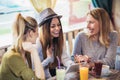 Friends enjoying in conversation and drinking coffee in c Royalty Free Stock Photo