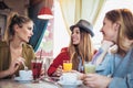 Friends enjoying in conversation and drinking coffee in cafe Royalty Free Stock Photo