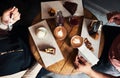 Friends enjoying desserts and coffee together in a cafe Royalty Free Stock Photo