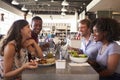 Friends Enjoying Lunch Date In Delicatessen Restaurant Royalty Free Stock Photo