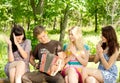 Friends enjoying music played on a concertina Royalty Free Stock Photo