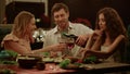 Friends enjoying outdoor dinner on backyard. Man flirting with women Royalty Free Stock Photo