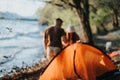 Friends enjoying a relaxing lakeside camping trip on a sunny weekend