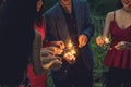 Friends enjoying sparklers in the night party. Group of friends playing fireworks together. Royalty Free Stock Photo