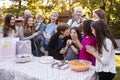 Friends and family gathered at a garden birthday party Royalty Free Stock Photo