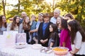 Friends and family gathered in a garden for a birthday party Royalty Free Stock Photo