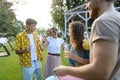 Friends and family talking and having fun at a summer grill garden party. People at the party dancing, laughing, holding Royalty Free Stock Photo