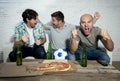 Friends fanatic football fans watching game on tv celebrating goal screaming crazy happy