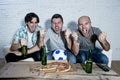 Friends fanatic football fans watching game on tv celebrating goal screaming crazy happy