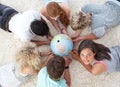 Friends on the floor examining a terrestrial world Royalty Free Stock Photo