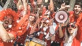 Friends football supporter fans cheering with confetti watching Royalty Free Stock Photo