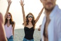 Friends dance on beach under sunset sunlight, having fun, happy, enjoy Royalty Free Stock Photo