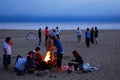 Friends gather around a bonfire