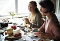 Friends Gathering Together on Tea Party Eating Cakes Enjoyment h Royalty Free Stock Photo