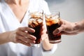 Friends with glasses of cold cola on color background Royalty Free Stock Photo