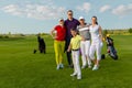 Friends golfers with kid happy to finish their golf game