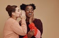 Friends, gossip and black woman laughing at secret on studio background and product placement mockup. Secrets, rumor and Royalty Free Stock Photo