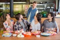 Friends greeting young man in restaurant Royalty Free Stock Photo