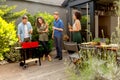 Friends grilling food and enjoying barbecue party outdoors Royalty Free Stock Photo