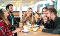 Friends group drinking cappuccino at coffee bar - People talking and having fun together at fancy cafeteria - Friendship concept Royalty Free Stock Photo