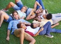 Friends, group and grass or lying in circle in park or university relax, student peers or happy. Man, woman and portrait Royalty Free Stock Photo