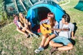 Friends group having fun outdoor singing at picnic camp with vintage guitar - Young people enjoying summer time together Royalty Free Stock Photo