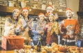 Friends group with santa hat celebrating Christmas time with champagne and sweets food at dinner party - Winter holiday concept Royalty Free Stock Photo