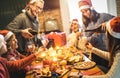 Friends group with santa hats celebrating at Christmas dinner party Royalty Free Stock Photo