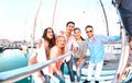 Friends group taking selfie pic with stick on luxury sailing boat party trip - Friendship concept with young millenial people Royalty Free Stock Photo