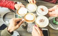 Friends group toasting cappuccino and milk with cocoa - Close up of young people drinking in coffee shop bar restaurant -
