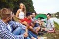 Friends with a guitar on a picnic on nature in autumn. Royalty Free Stock Photo