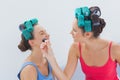 Friends in hair rollers having fun with makeup Royalty Free Stock Photo