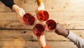 Friends hands toasting red wine glass and having fun cheering with winetasting - Young people enjoying time together at a wine bar Royalty Free Stock Photo