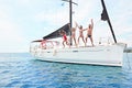 Friends hanging out, having fun and enjoying summer days jumping from sailing boat in sea Royalty Free Stock Photo