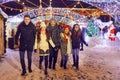 Friends have fun walking on Christmas streets at night.